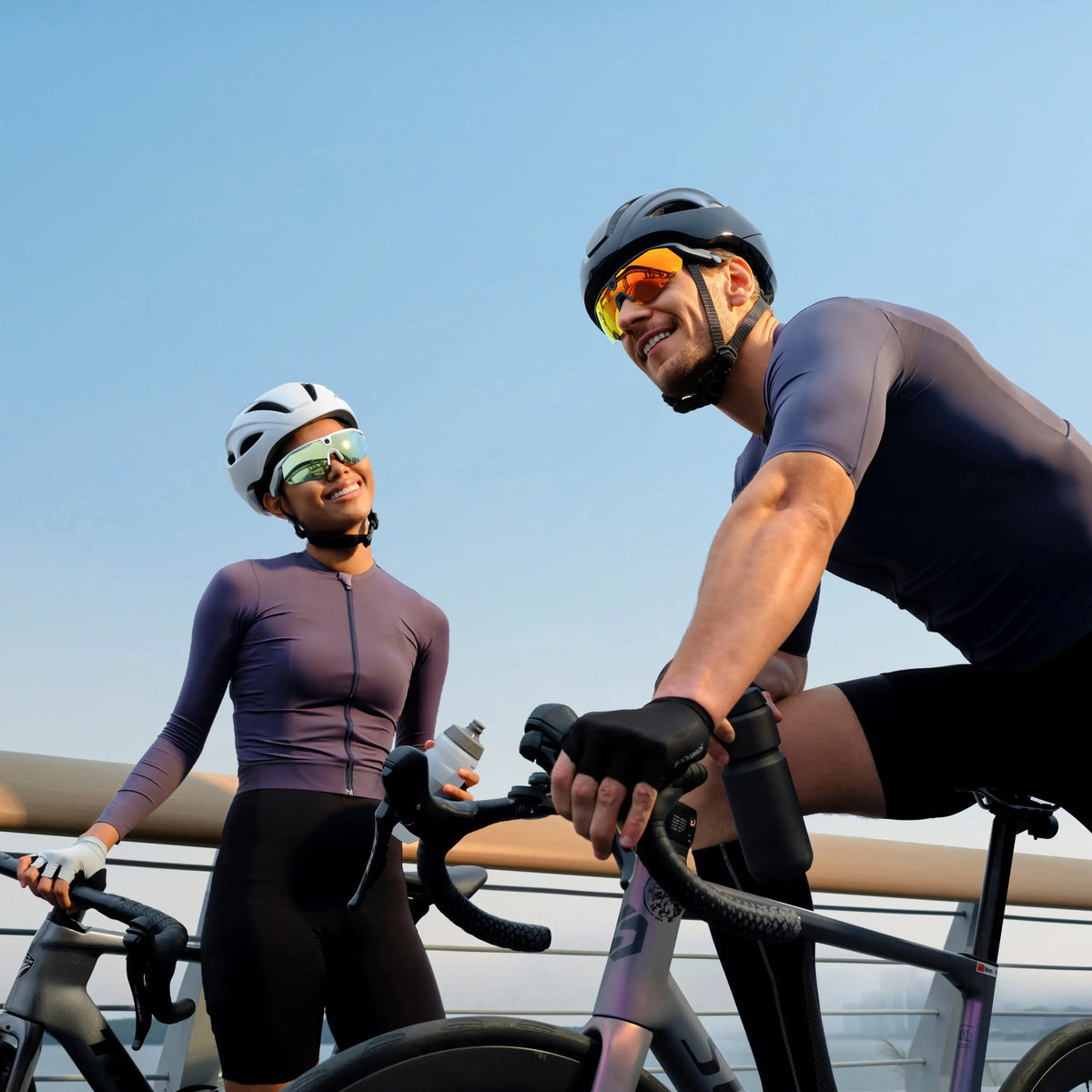 Two cyclists wearing BleeqUp Ranger AI sports camera glasses